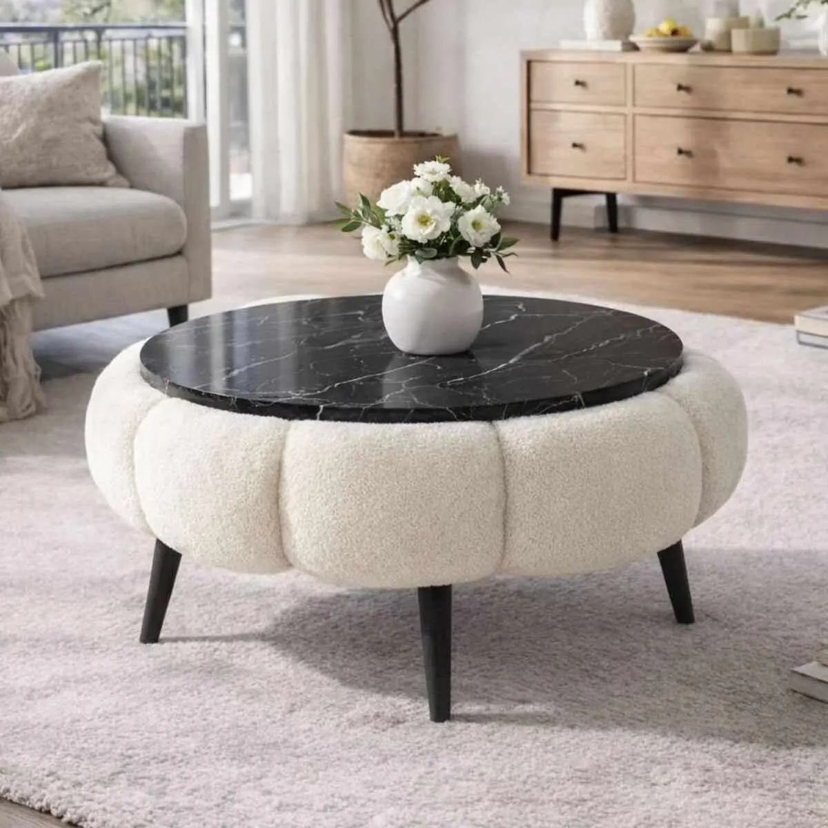 image stolik kawowy, blat czarny, marmurowy, sofa w stylu skandynawskim, podstawa drewniana, wazon z kwiatami