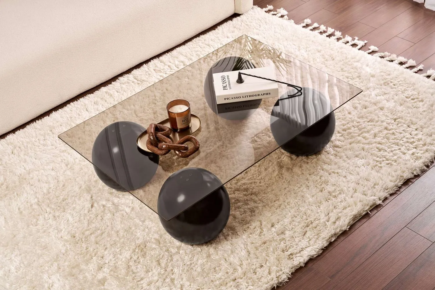 Stolik kawowy SERA 75x110 cm nogi czarne kule blat szklany brązowy - ASI_857NRD1121